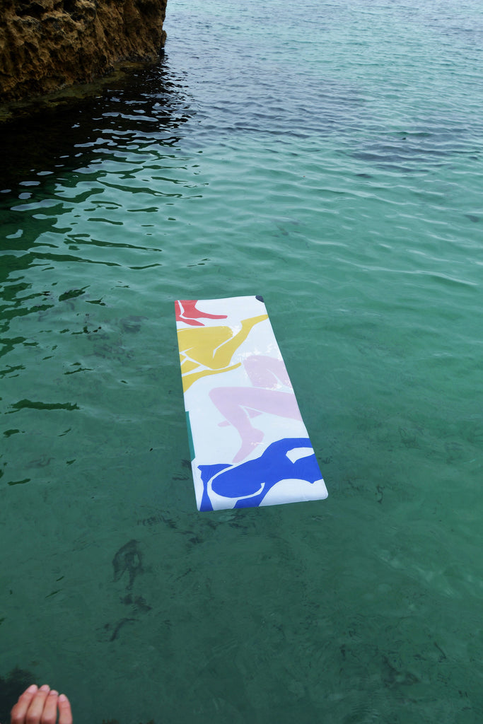 Colourful print yoga mat suede floating in ocean product shot
