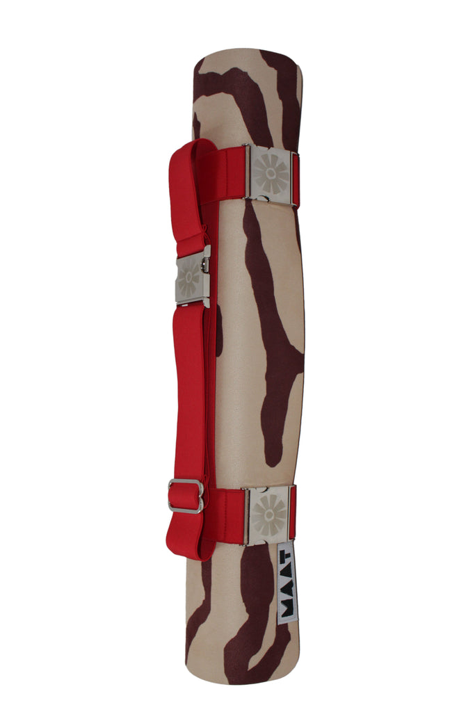 Red strap around rolled up 'tiger' yoga mat