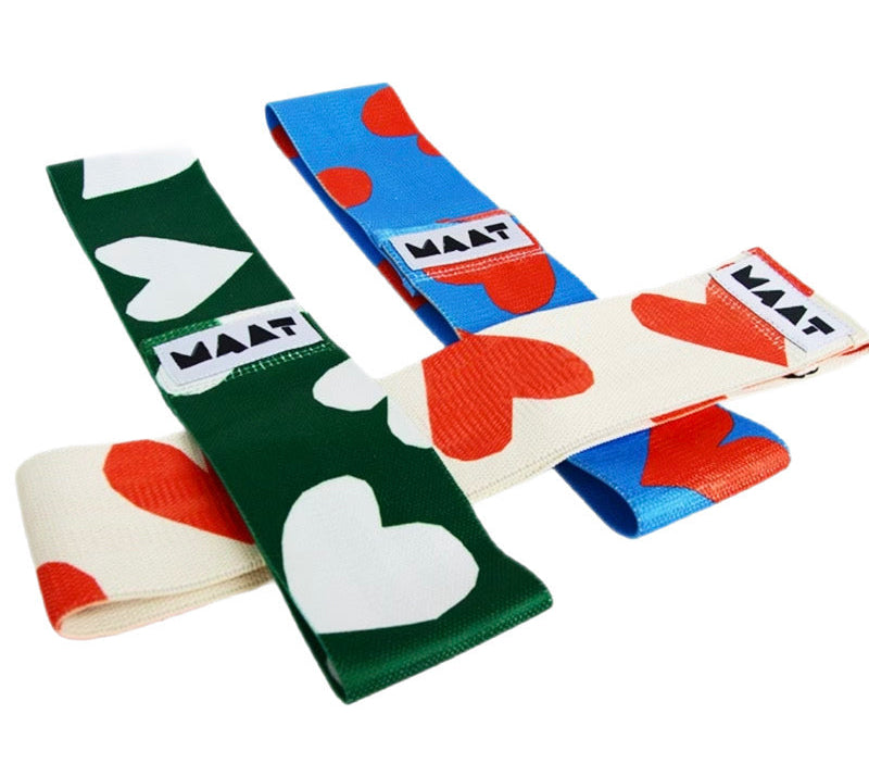 Three colorful resistance bands with heart patterns and 'MAAT' branding on a white background.