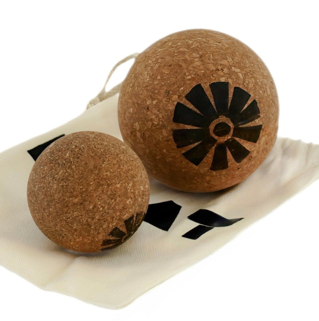 Two brown spherical objects with black designs on a white background