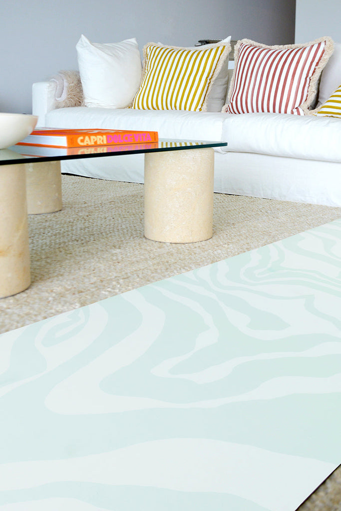 Mat laying by the side of the tea table and sofa