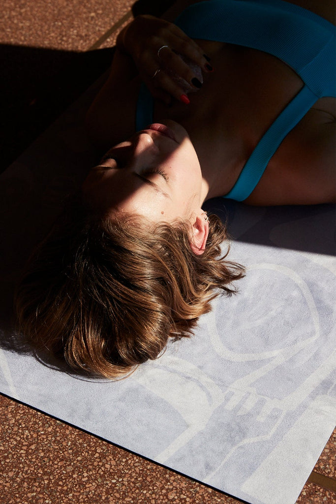Girl laying with head on the corner of mat