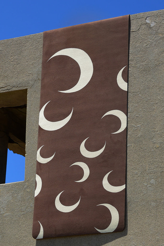 Flatlay mat hanging on the concrete wall with a window