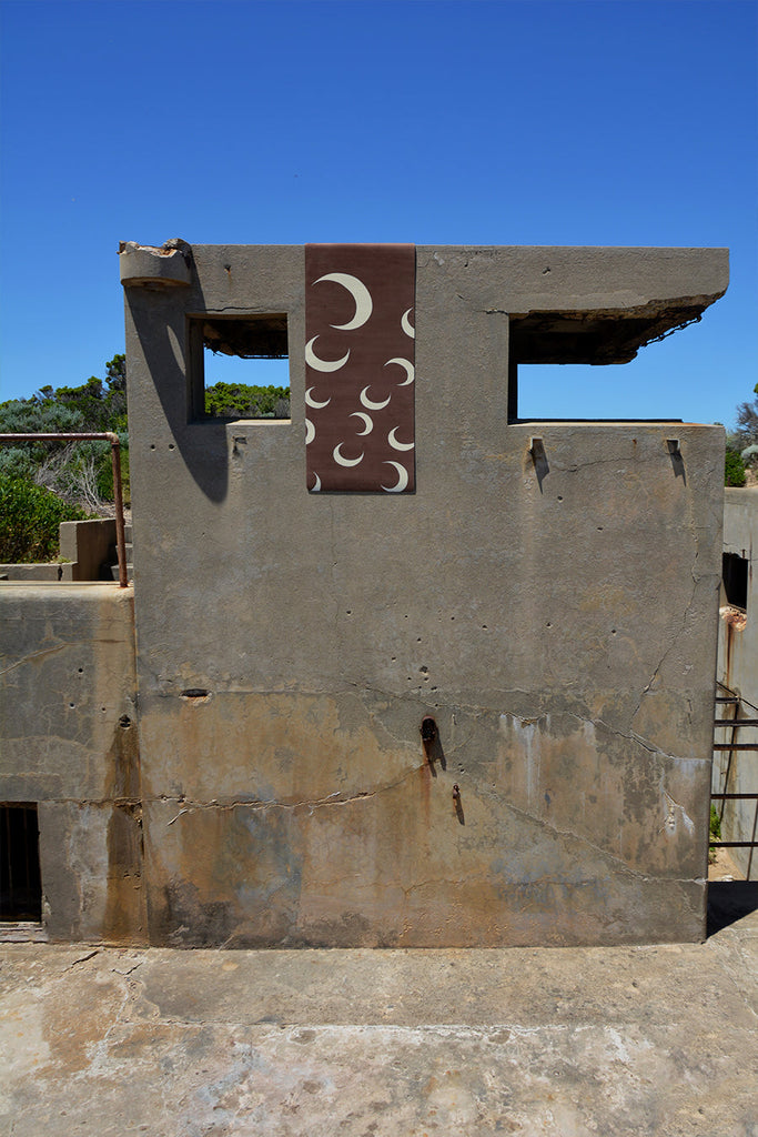 Mat hanging on the concrete wall with broken windows