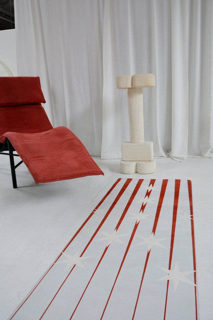 Flatlay mat by the side of the red sofa chair