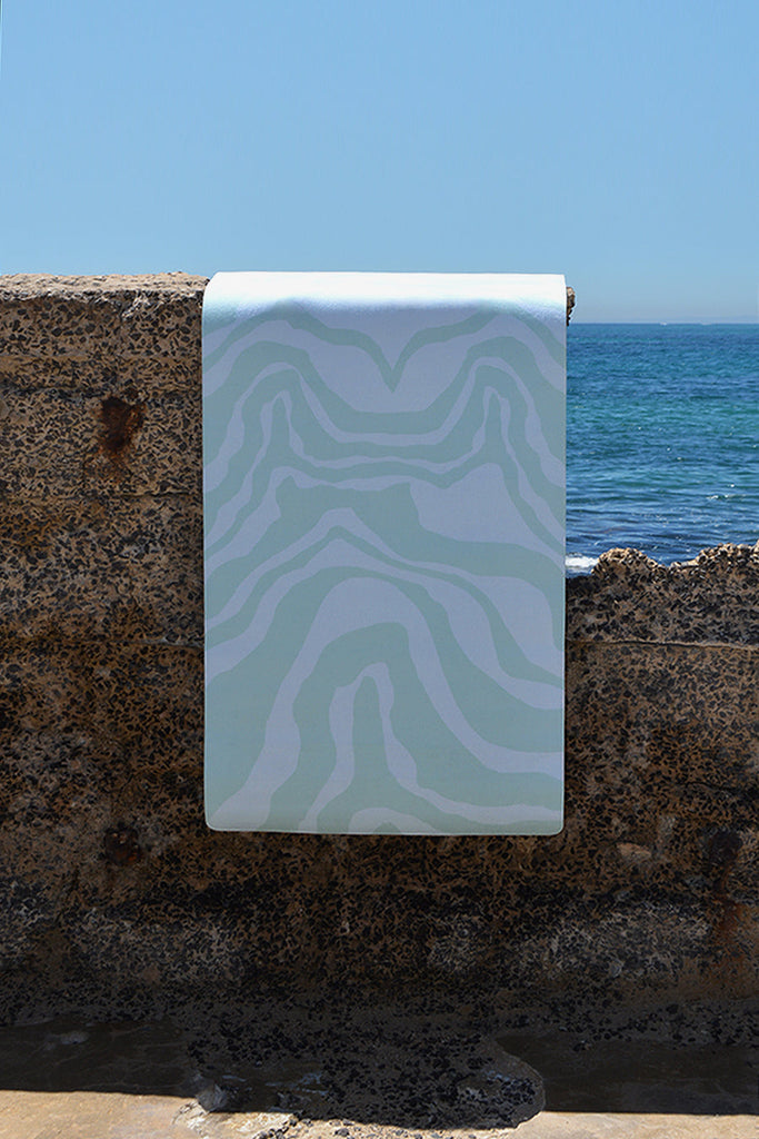 Mat hanging on the concrete wall by the sea