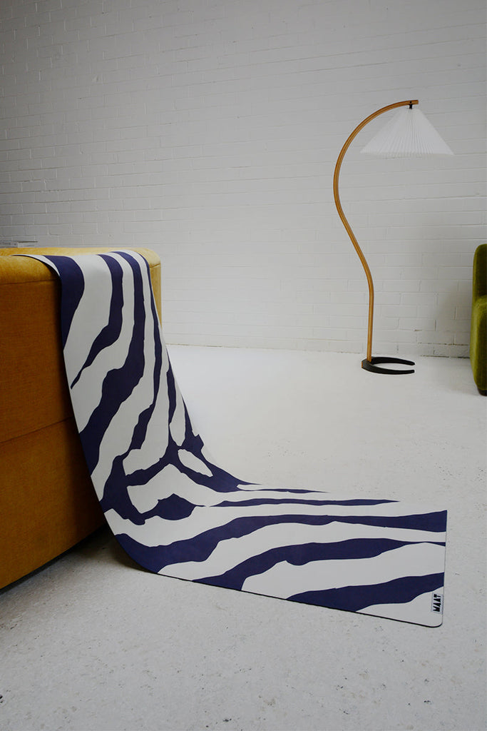 Mat reclining from yellow sofa to the floor