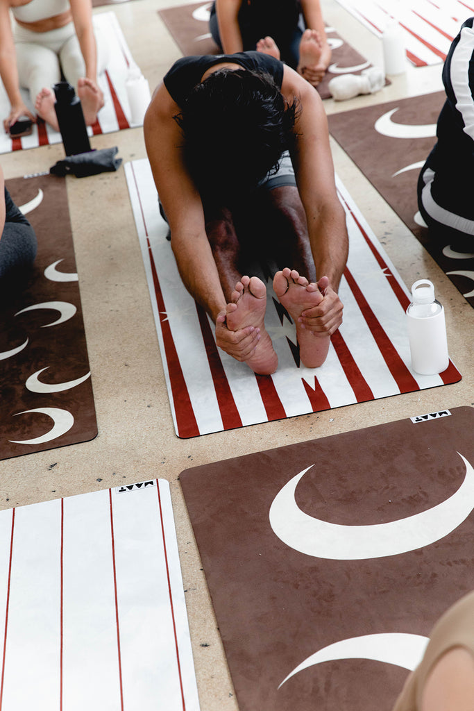 Man stretching on a yoga mat