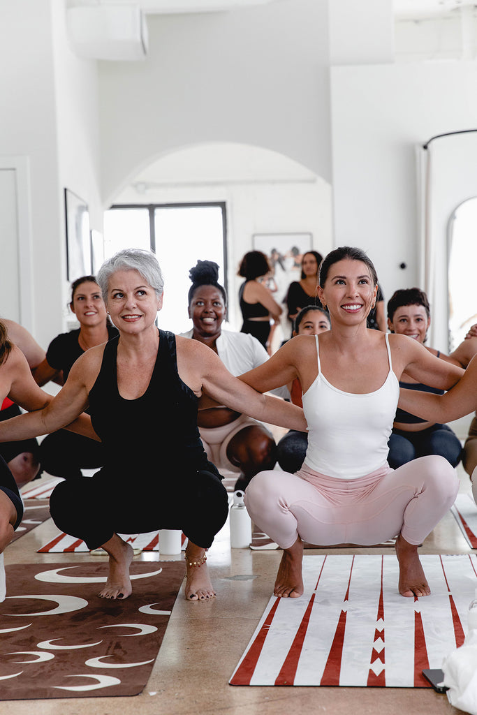 A group of women stretching in a yoga class