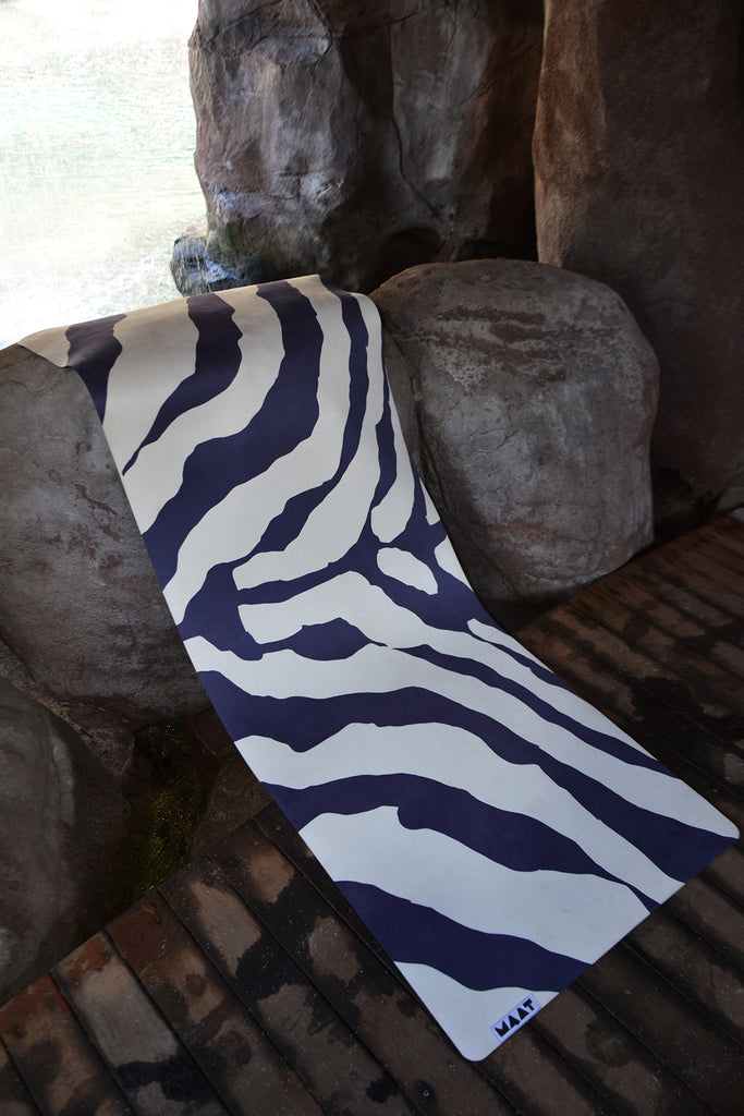 Yoga mat at the beach, lying on a rock