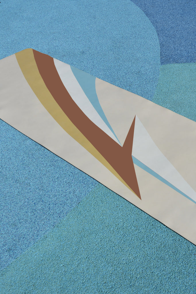 yoga mat on textured ground light blue and green