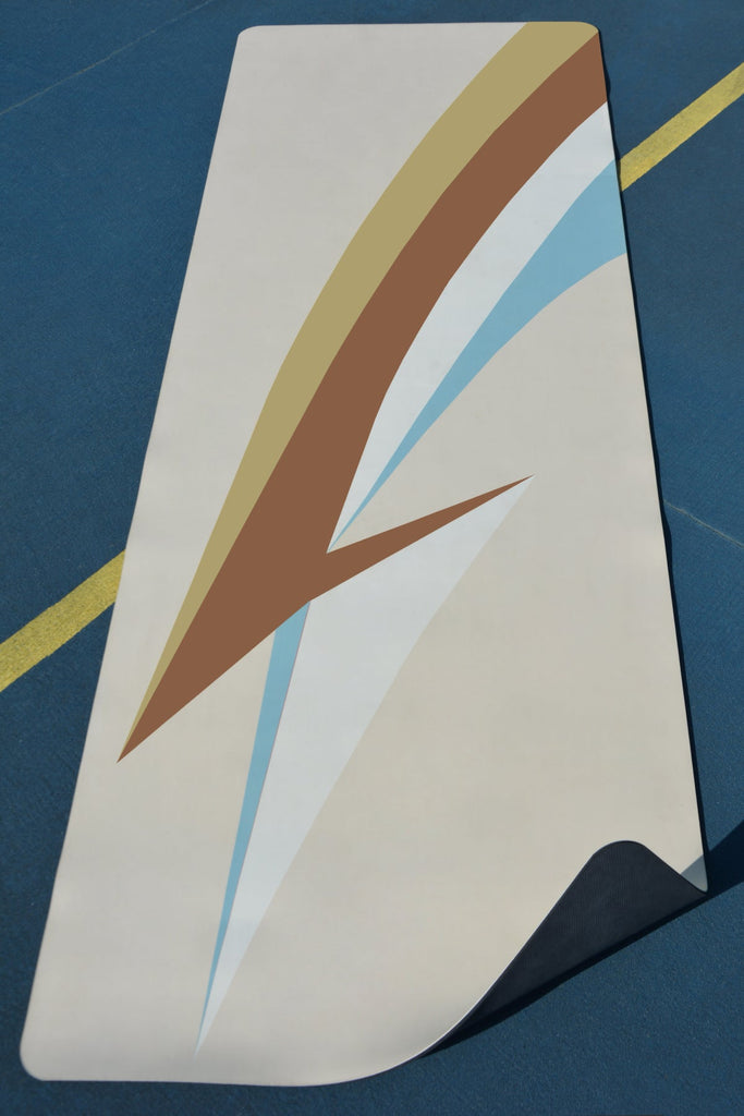 yoga mat on blue tennis court yellow line going through corner folded upwards