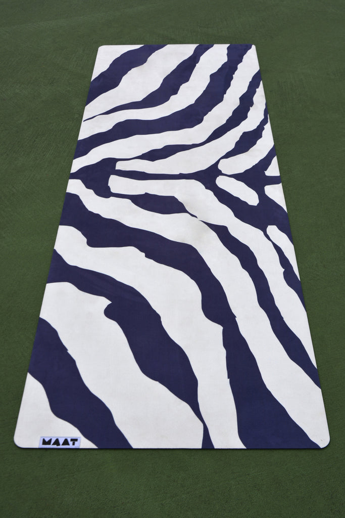 Zebra print flatlay yoga mat green floor