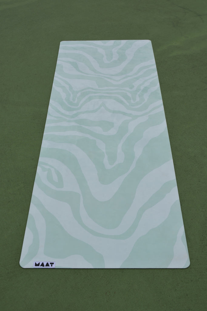 Full product shot green print yoga mat on green floor