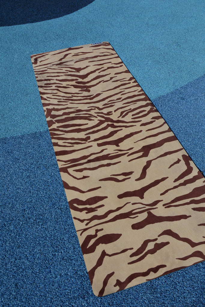 tiger print yoga mat product shot blue floor
