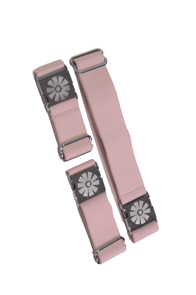 Two pink straps with metal buckles on a white background