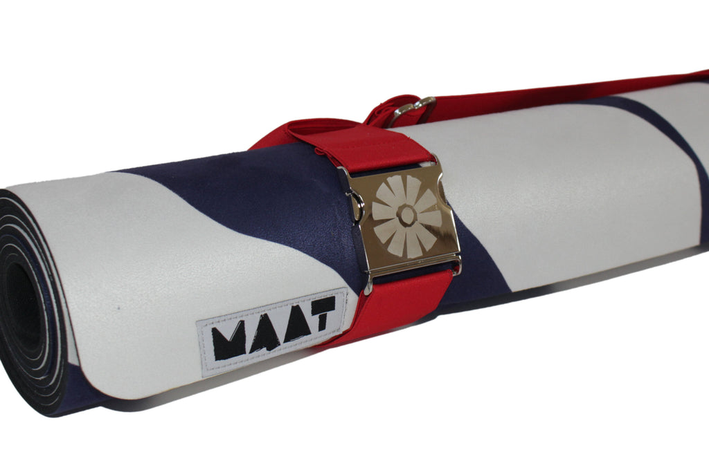 Red strap around rolled up 'zebra' yoga mat