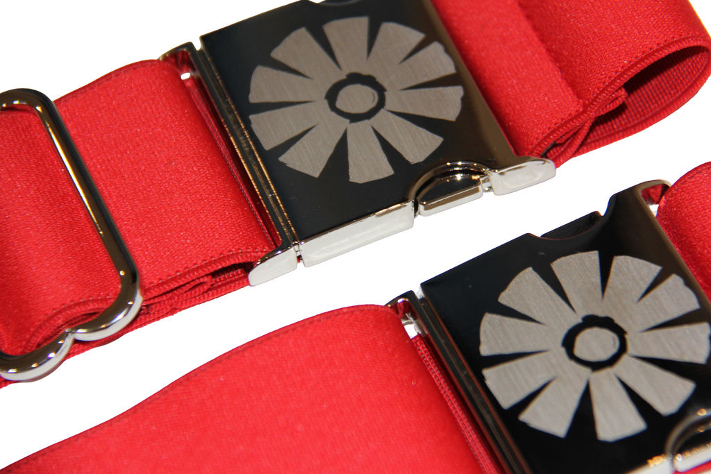 Red strap with metallic buckle featuring a floral design on a white background