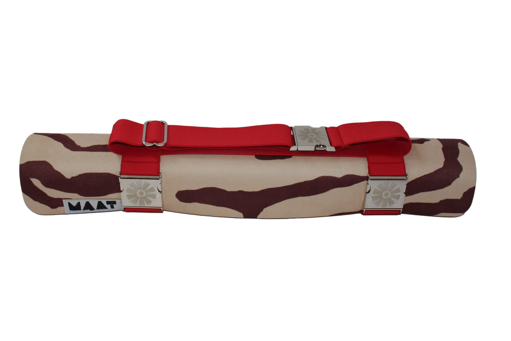 Red strap around rolled up 'tiger' yoga mat
