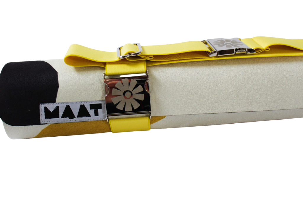 Yellow maat world straps on rolled yoga mat