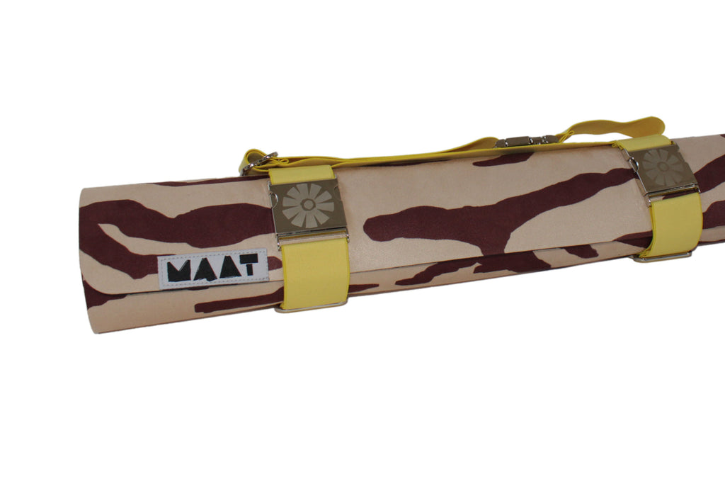 Yellow strap around 'tiger' yoga mat 
