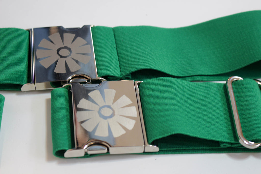 Green belt with silver floral buckles on a white background