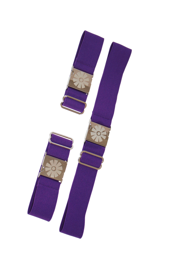 Two purple straps with floral metal buckles on a white background