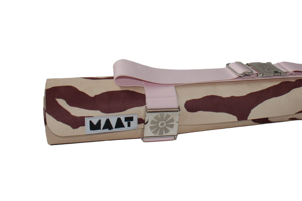 Camouflage-patterned yoga mat with pink strap and 'MAAT' branding on a white background