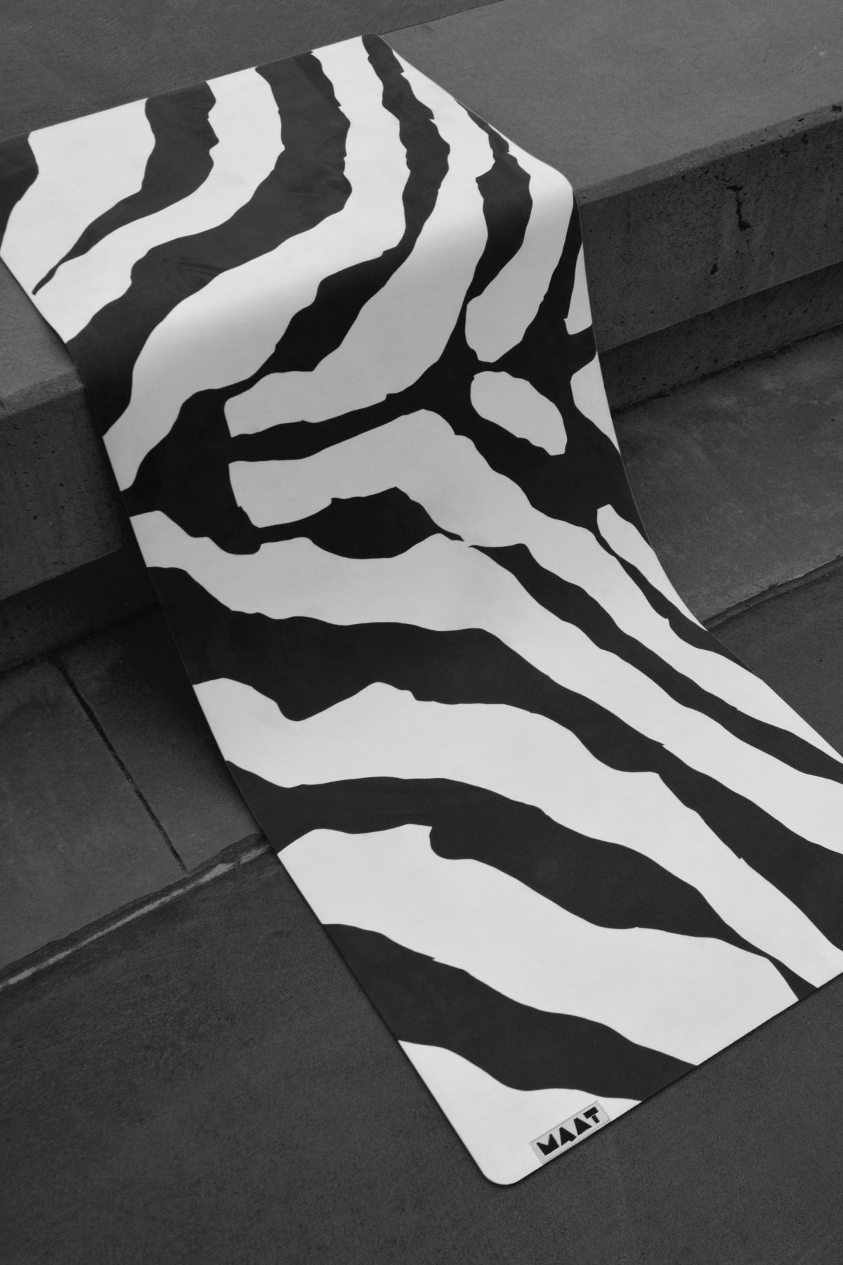 Zebra print yoga mat monochrome hanging on bench