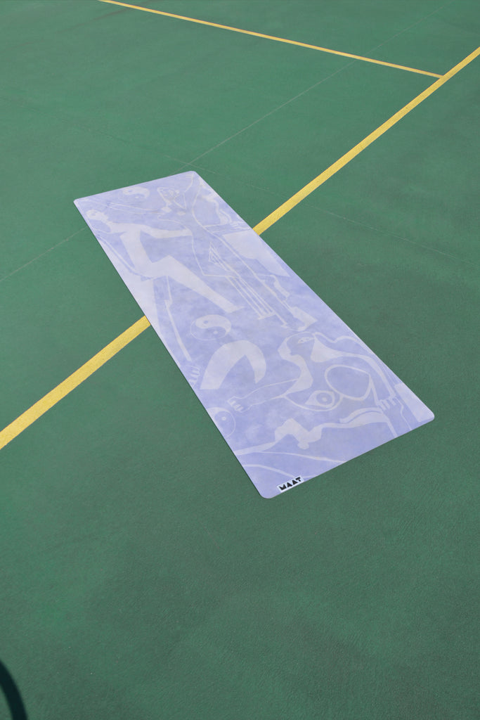 Yoga Mat on Green Tennis Court 