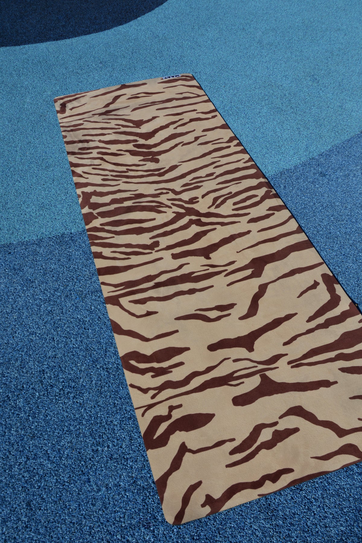 tiger print yoga mat product shot blue floor